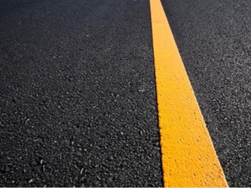 A single yellow line on a road