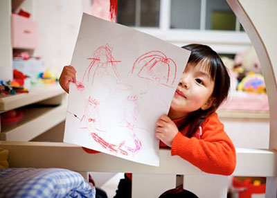 photo of young girl with drawing