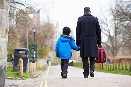 Child and parent walking to school
