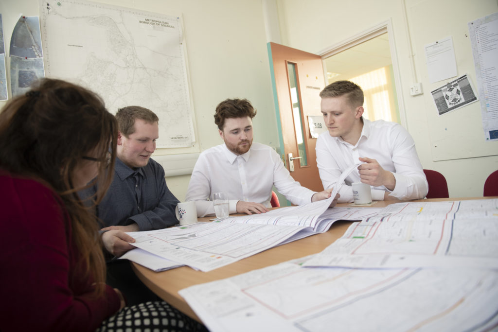 Apprentices looking at plans