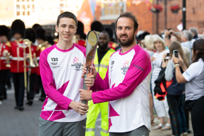 Two runners with baton