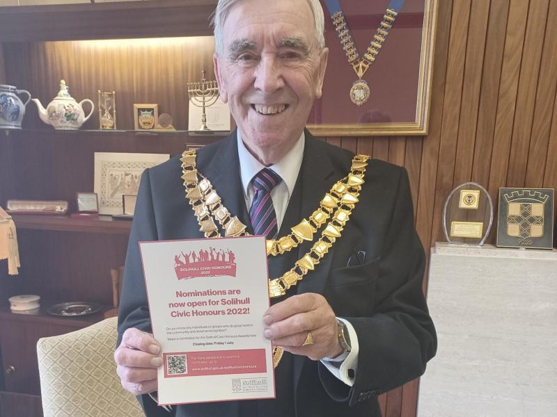 Councillor Ken Meeson, Mayor of Solihull, holding the flyer for Civic Honours Nominations