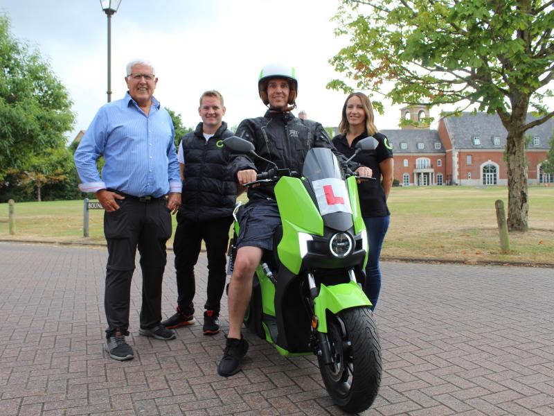 Nick Chadaway on an e-moped with Cllr Hawkins and silence UK members