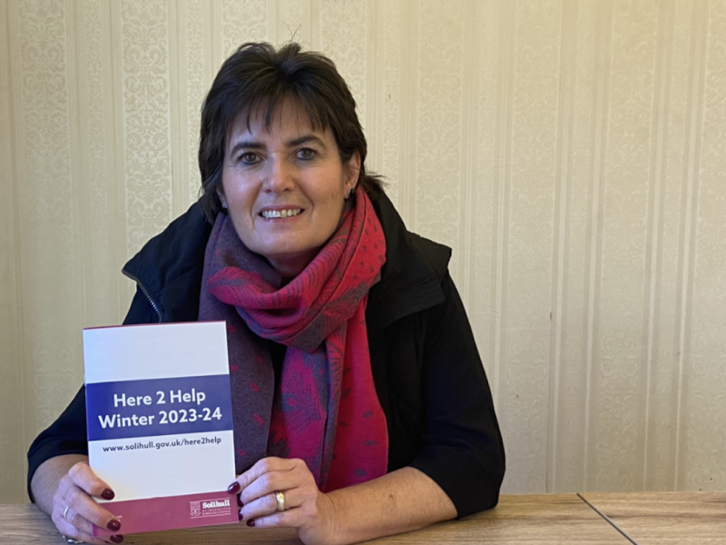 Cllr Grinsell with a Here2Help booklet