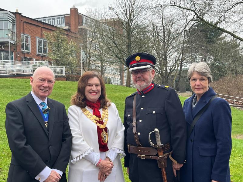 From left to right: Mayor's Consort Mr John Courtenay, Mayor of Solihull Councillor Diana Holl-Allen MBE, Deputy Lieutenant of the West Midlands Christ Loughran and Mrs Jane Loughran standing in front of the raised Commonwealth flag