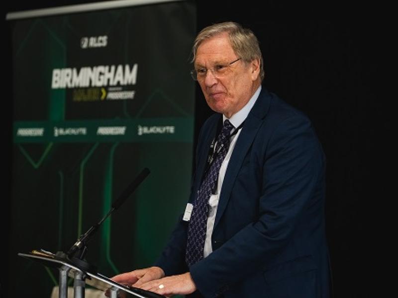 Councillor Ian Courts standing on the stage opening the esports business and innovation summit 