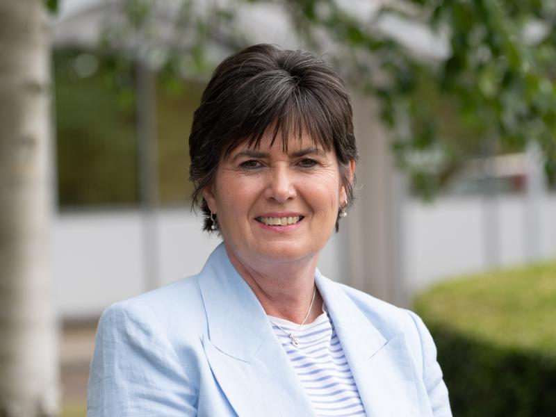 Councillor Karen Grinsell stands smiling outside the solihull council house
