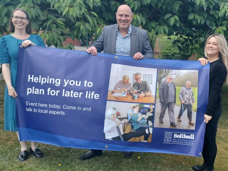 Cllr Dicicco and staff holding event banner