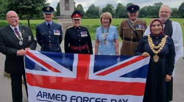 Ken Russell (Chair of RBL Shirley), Squadron Leader Dave Kerrison, Lesley Wilde TD DL, Elaine Butler (President of the Warwickshire & Birmingham County RBL), Captain Alan O'Brien, Mayor of Solihull and Mayor's Chaplain Revd Paul Day holding the Armed Forces Day flag at the RBL Memorial in Shirley Park