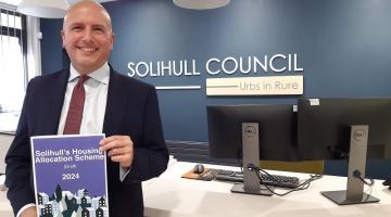 Cllr Parker with a copy of the draft housing allocations scheme