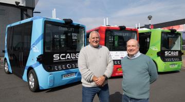 Cllr Andy Mackiewicz (right) with Ian Pulford from Ohmio (left) stood in front of the SCALE fleet