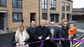 Cllr Mark Parker, Cllr Ian Courts and Cllr Andy Mackiewicz joined by Kinghurst residents outside the new Mountfort homes