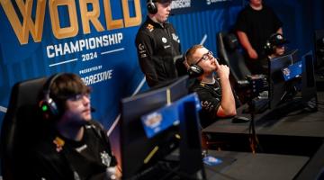 Staff at Rocket League World Championship 2024 sitting behind monitors with headsets on 