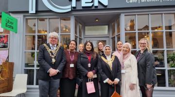 The Mayor of Solihull and the Lord Mayor of Birmingham stood outside a cafe where they have enjoyed tea and cake with the women from Anawim: Birmingham Centre for Women 