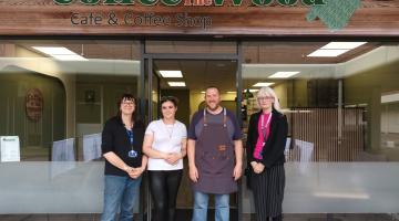 Rebecca, Taylor, Al and Cllr Delaney standing in front of the cafe