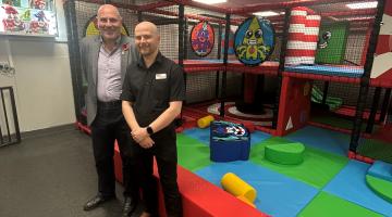 Cllr Dicicco and James Forsyth standing in front of the soft play area at North Solihull Sports Centre