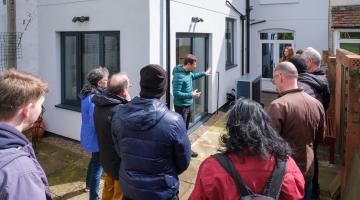 The Green Doors team taking a small group on a tour of a retrofitted home in south Birmingham