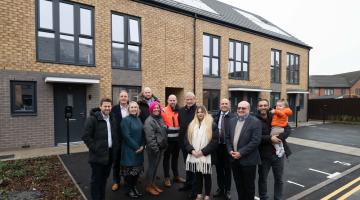 Members of the project team and Solihull Council Cabinet Members joined by Kingshurst residents outside the Mountfort development.