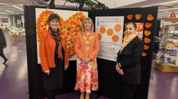 Cllr Grinsell, Cllr Mackenzie and Cllr Qais, standing in front of a floral display at The Core
