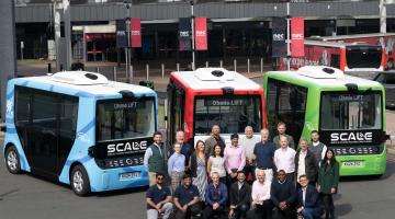 Consortium members gathered in front of the SCALE fleet