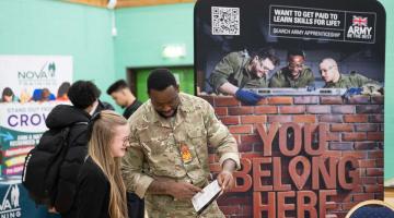 a young person talking with an exhibitor at the Solihull Apprenticeship and Pathways Show
