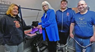 Jessie, Rufus, Cllr Delaney, Harry and Matt from Snooty Pooch CIC at a dog grooming taster session with the Youth Trailblazer programme