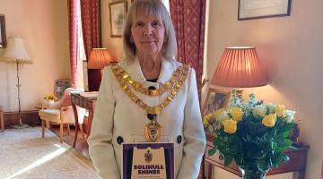 The Mayor of Solihull, Councillor Annette Mackenzie, with a flyer for Solihull Shines