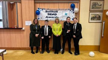 The Mayor of Solihull, three Lode Heath students and their teacher stand for a photo in front of a Solihull SEND Awards banner.