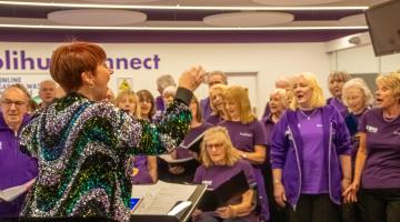 woman conducting choir group sing solihull at the core theatre 
