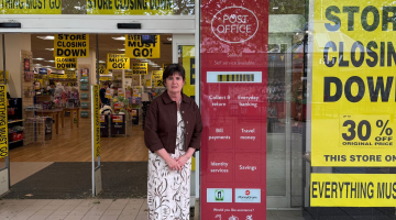 Councillor Karen Grinsell, Leader of Solihull Council, standing in front of the Post Office in Mell Square.