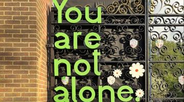 'You are not alone' sign on the gates of Malvern Park.