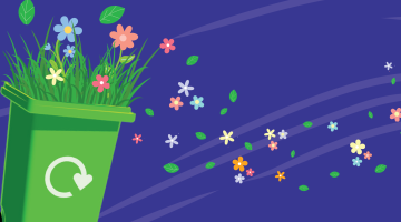 A garden waste bin, with flowers on top.