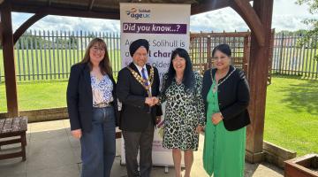 sally tomlinson, cllr marwa, anne hastings and mrs marwa in front of an age uk solihull pull up banner