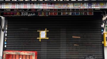 Outside of Boss Mart 2 with closure notice on shutters