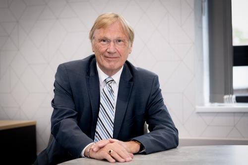 Councillor Ian Courts sits at a desk. 