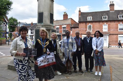 Leader of the Council, Councillor Karen Grinsell and the Mayor of Solihull, Annette Mackenzie standing with dignitaries next to a war memorial along the trail