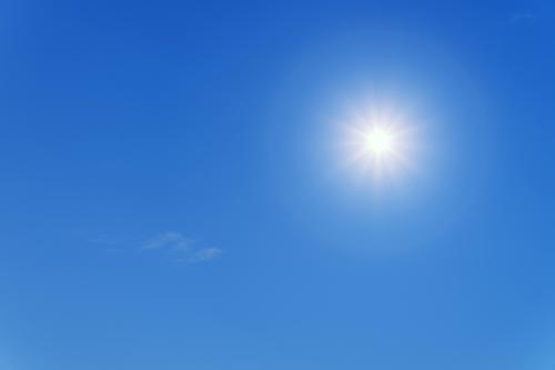 The sun shining, with a blue sky