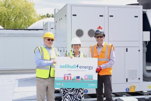 Cllr Andy Mackiewicz (Cabinet Member for Climate Change and Planning), Councillor Karen Grinsell (Leader of Solihull Council) and Dave Pardoe, Contracts Manager (Vital Energi) stood in front on the recently installed Air Source Heat Pumps