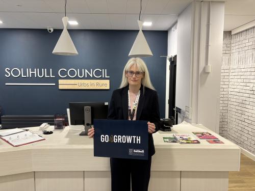 Councillor Heather Delaney stood with the logo of the Council's new partner Go4Growth