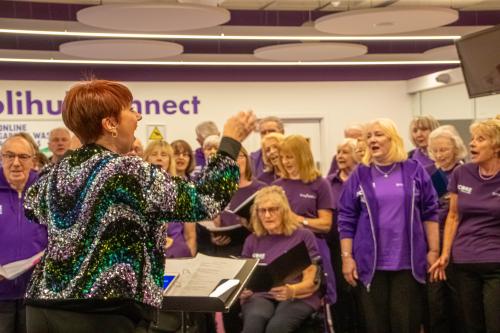 woman conducting choir group sing solihull at the core theatre 