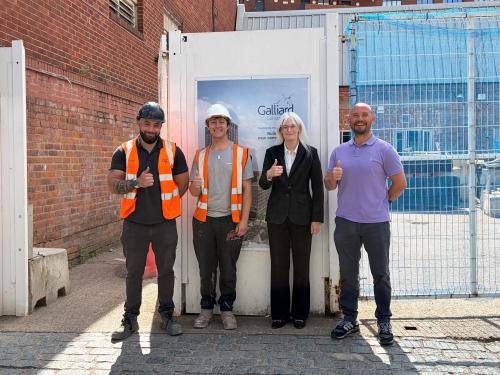 Matthew, Ryan, Cllr Delaney and Paul outside the construction site that Ryan's working at